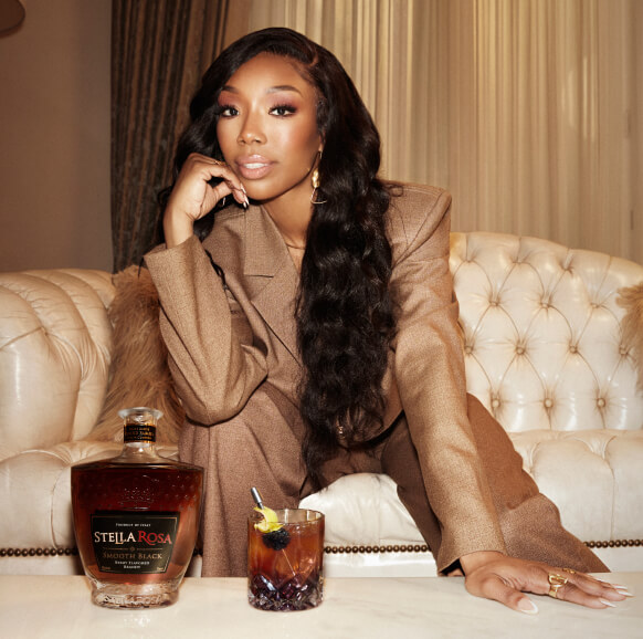 Woman siting on a sofa, enjoying Stella Rosa Smooth Black Brandy